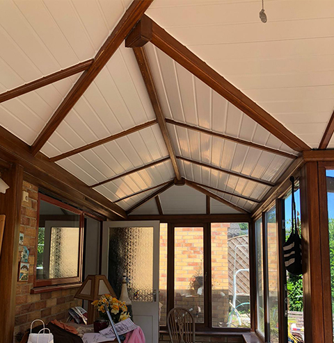 the roof of a conservatory, supported with wooden accents 